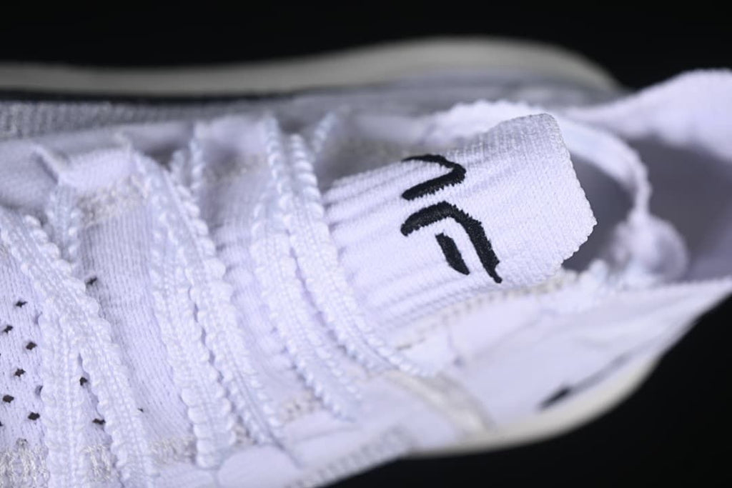 Close-up of the white laces and tongue tab