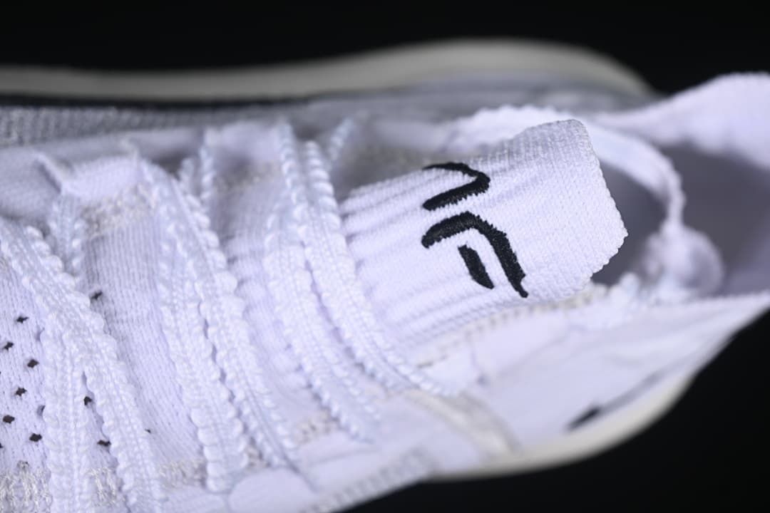 Close-up of the white laces and tongue tab