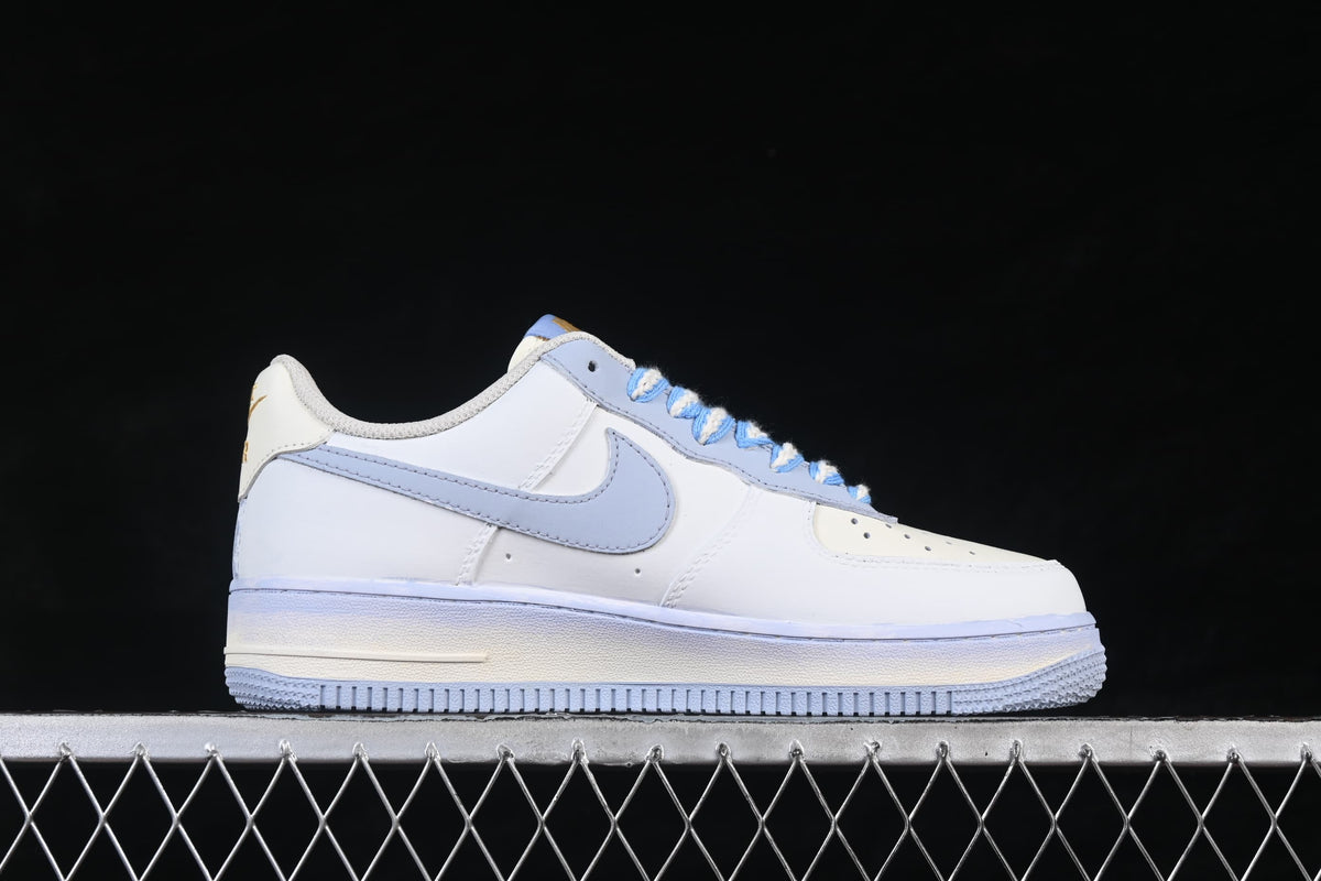 Side profile of a white Air Force 1 '07 sneaker with pale blue Swoosh and sole