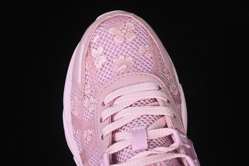 Top-down view of the sneaker toe with floral details over mesh-look panels.