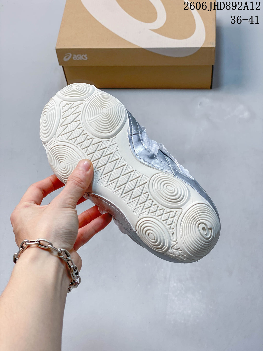 Close-up of the sneaker outsole with circular and geometric tread patterns