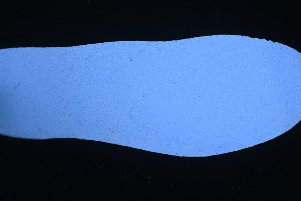 Blue-lit view of a shoe insole.