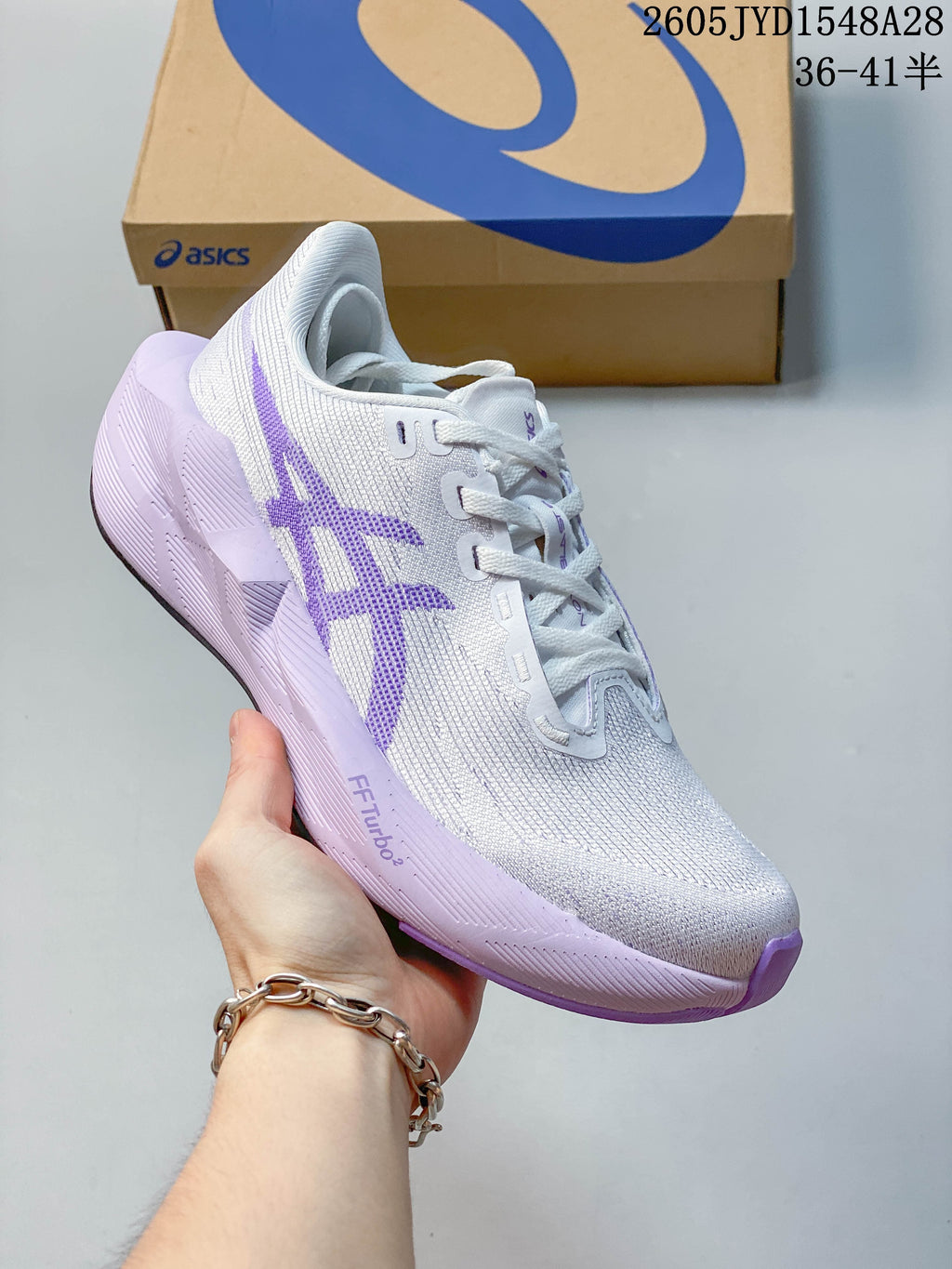 Angled view of a white and purple ASICS NOVABLAST 6 running shoe