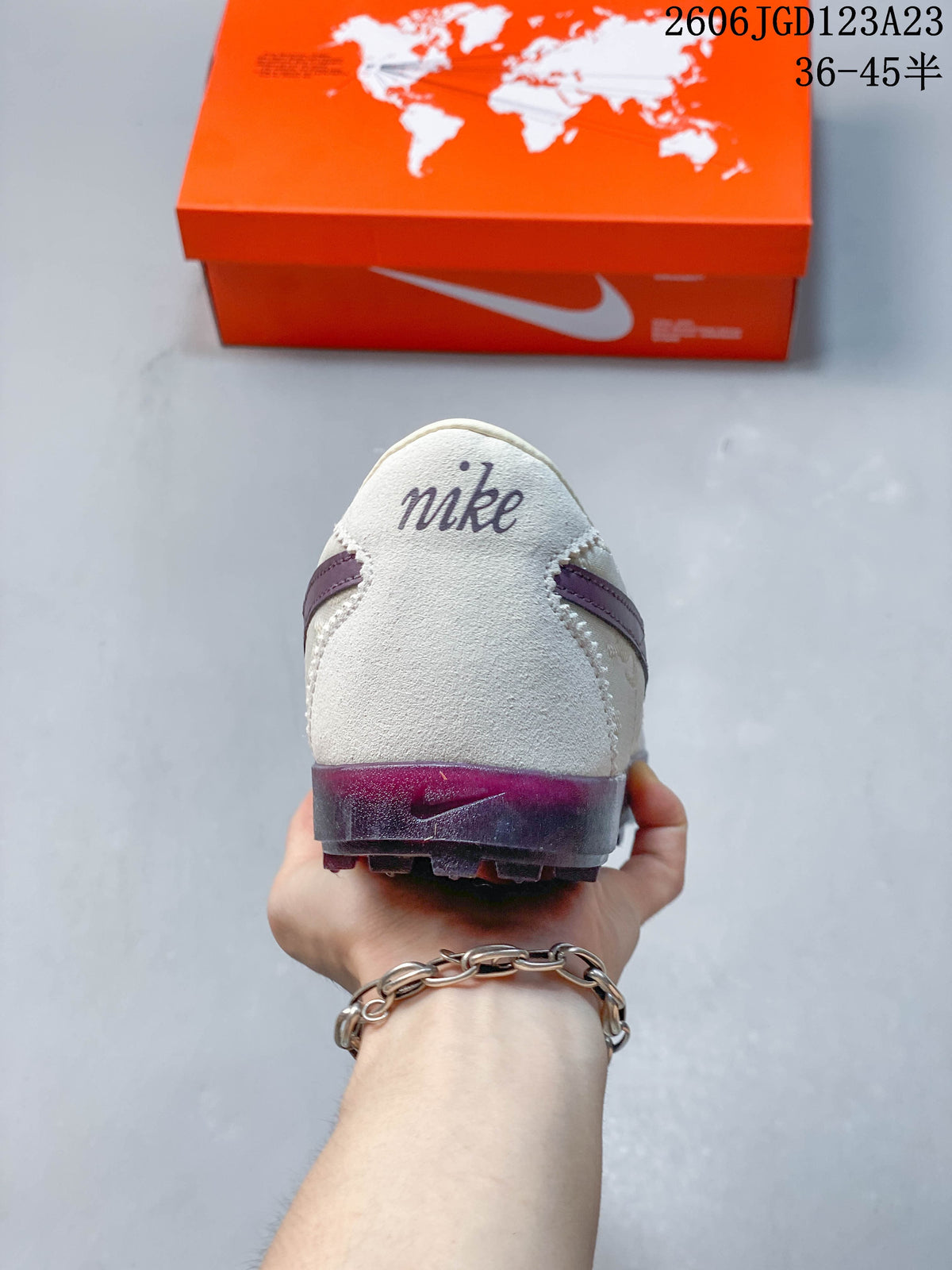 Rear view of the sneaker showing an off-white heel and plum-toned outsole