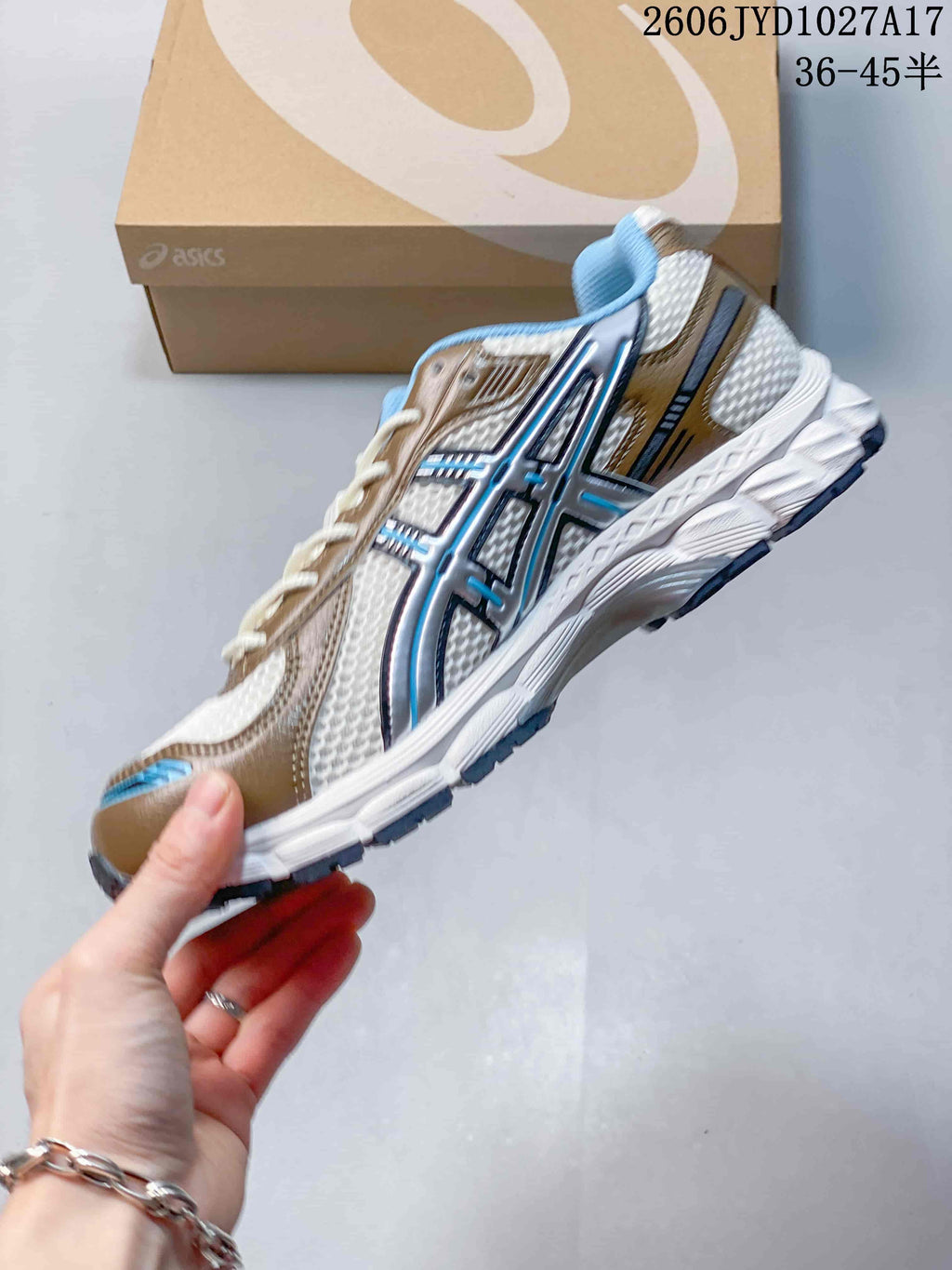 Side view of the white, tan, and blue ASICS Gel-Kayano 12.1 sneaker