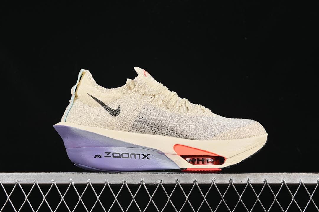 Side view highlighting the cream upper and purple heel section