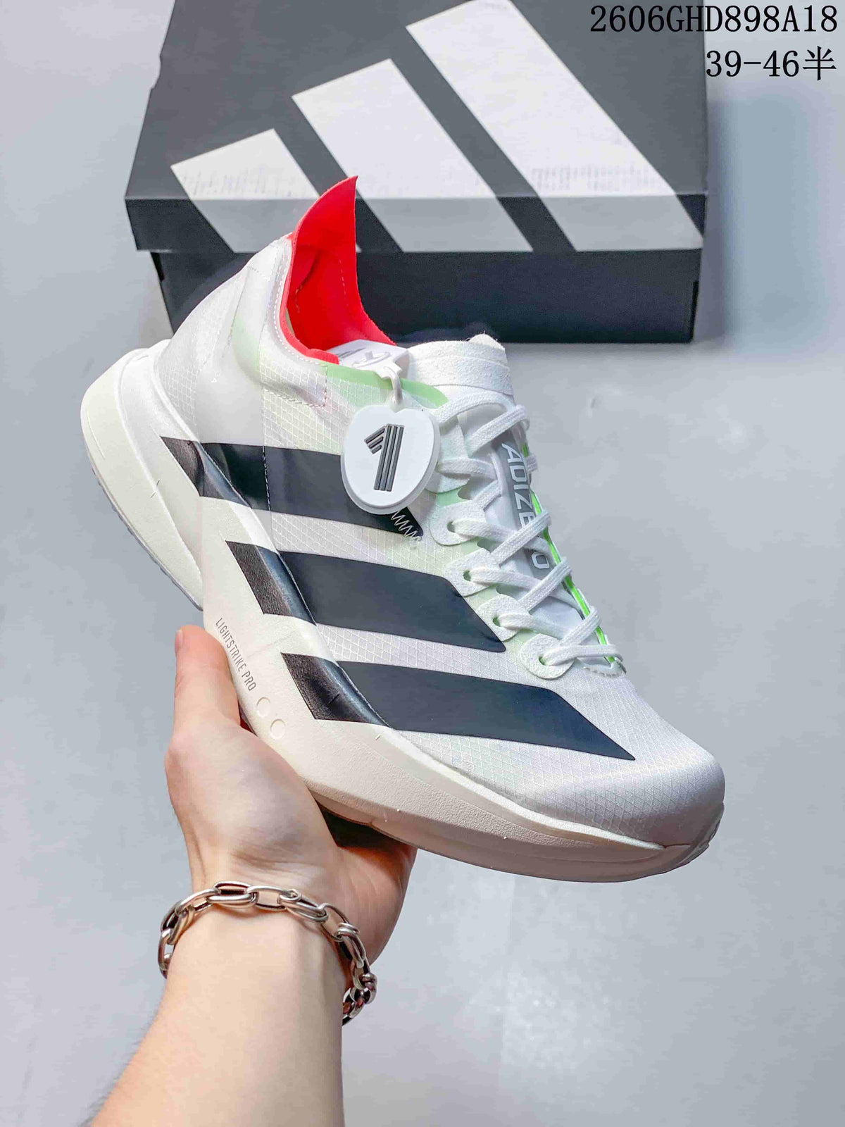 Side profile of the white running shoe with dark stripes and a sculpted midsole.