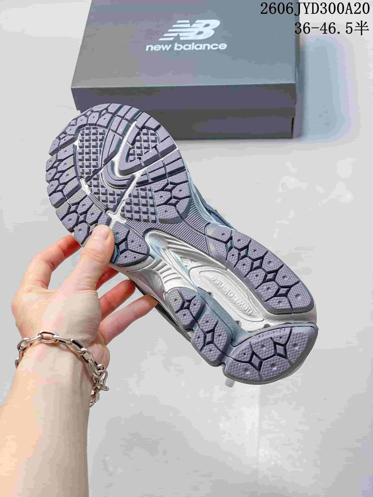 Patterned outsole of a grey New Balance 1906 sneaker