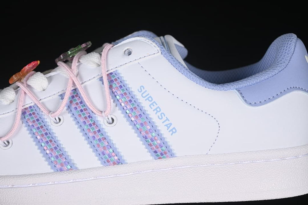 Close-up of pastel patterned side stripes and SUPERSTAR lettering