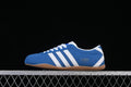 Side profile of a blue and white Adidas Tokyo sneaker with a gum-colored outsole