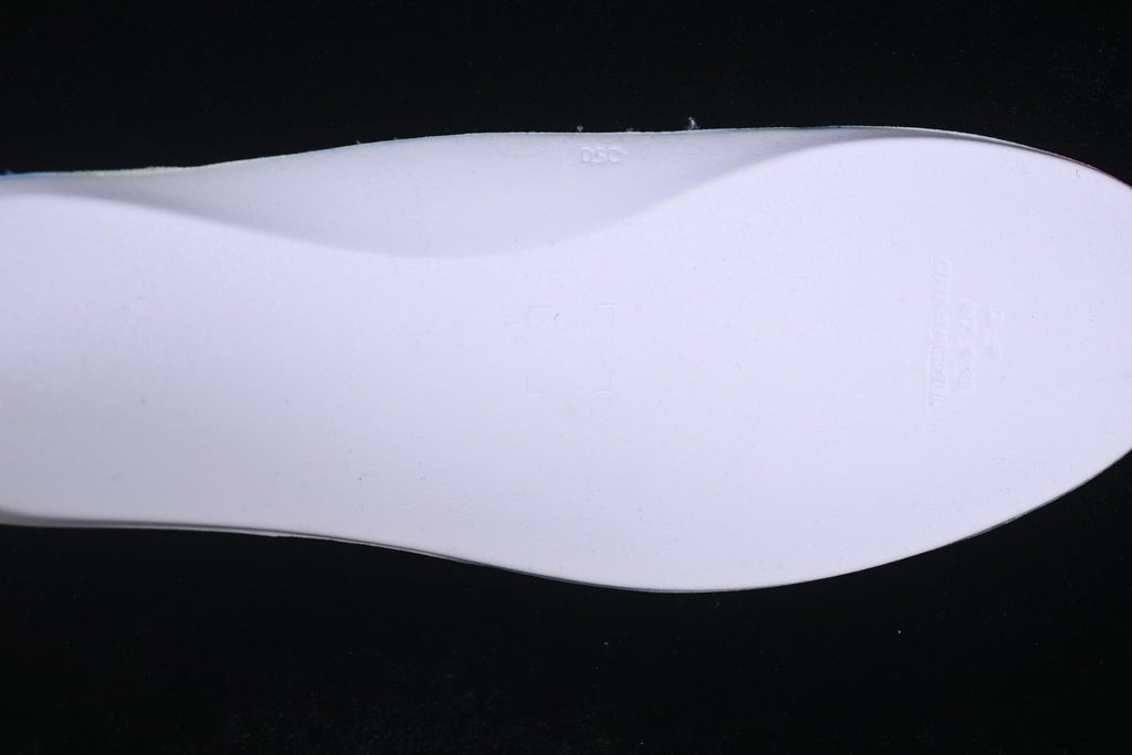 Close-up of the light-colored sneaker outsole.
