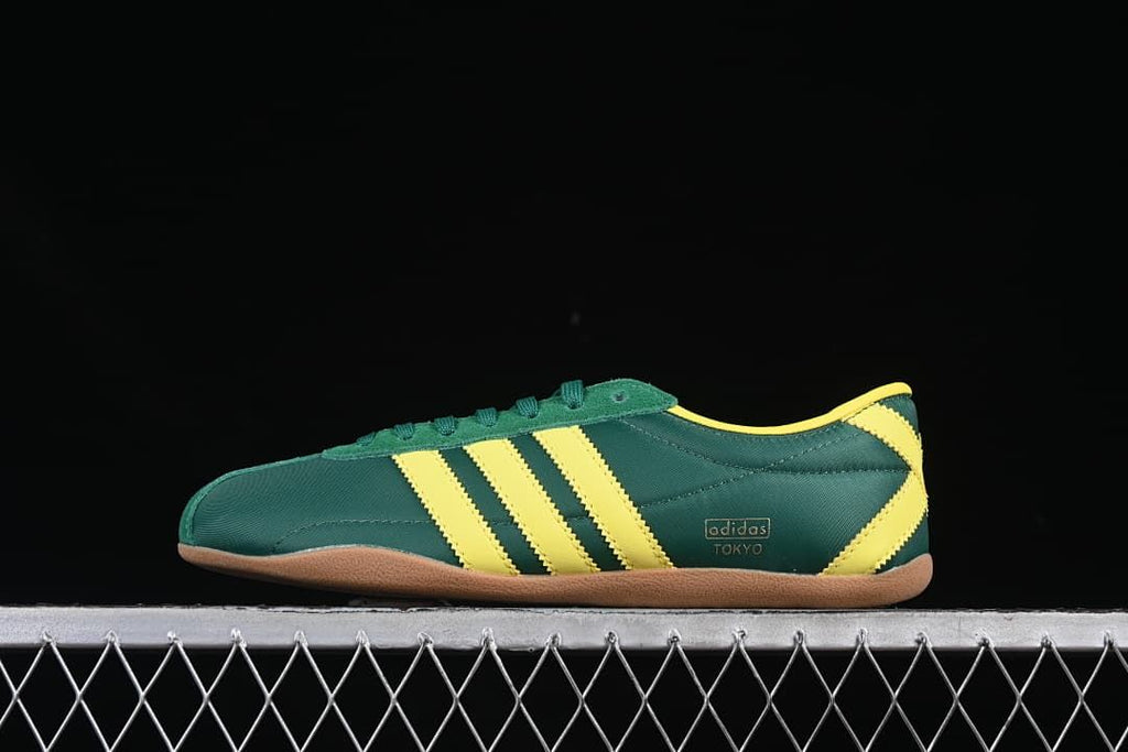 Side profile showing the green upper, yellow stripes and gum-colored outsole