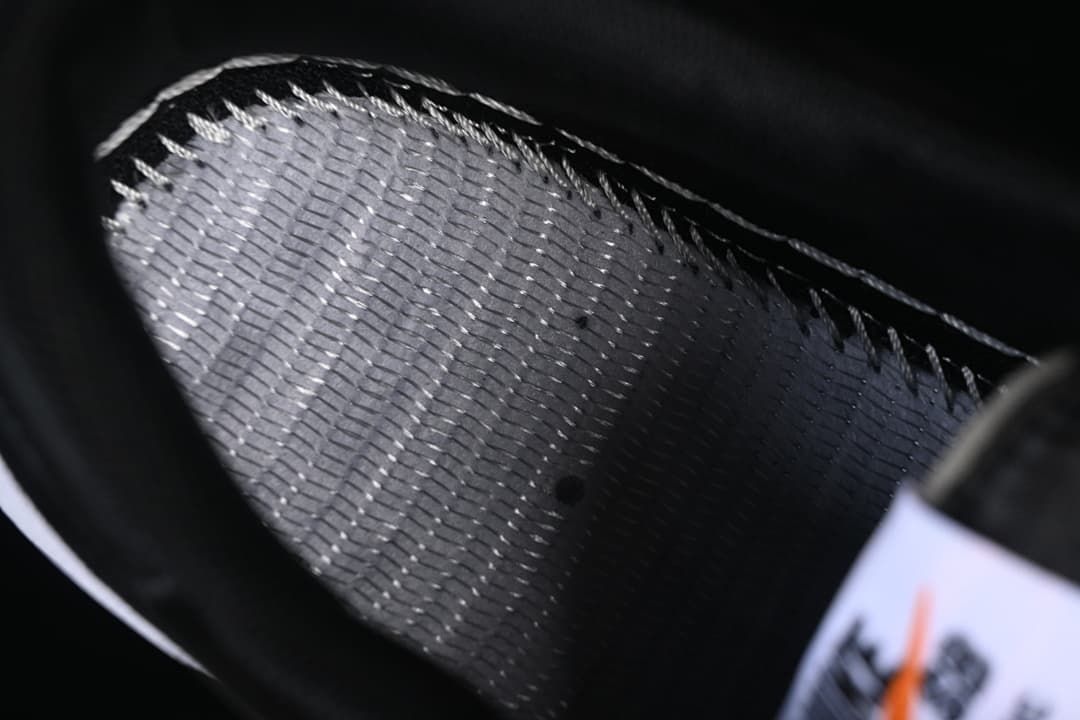 Close-up of the shoe's dark interior lining and stitching.