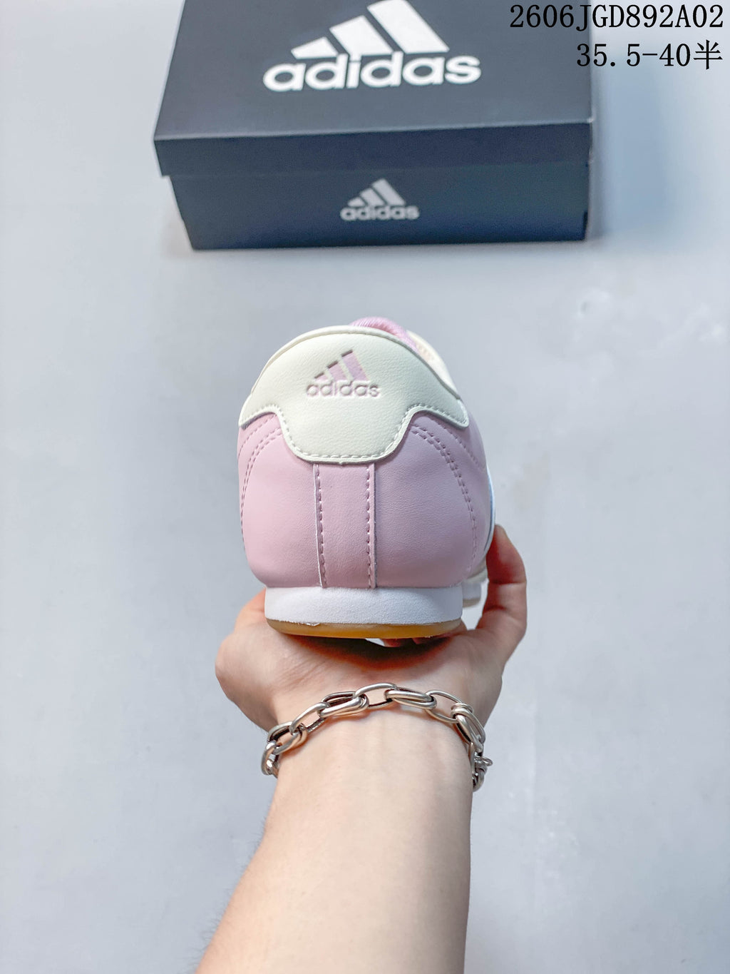 Rear view of a pink and off-white Adidas Taekwondo shoe