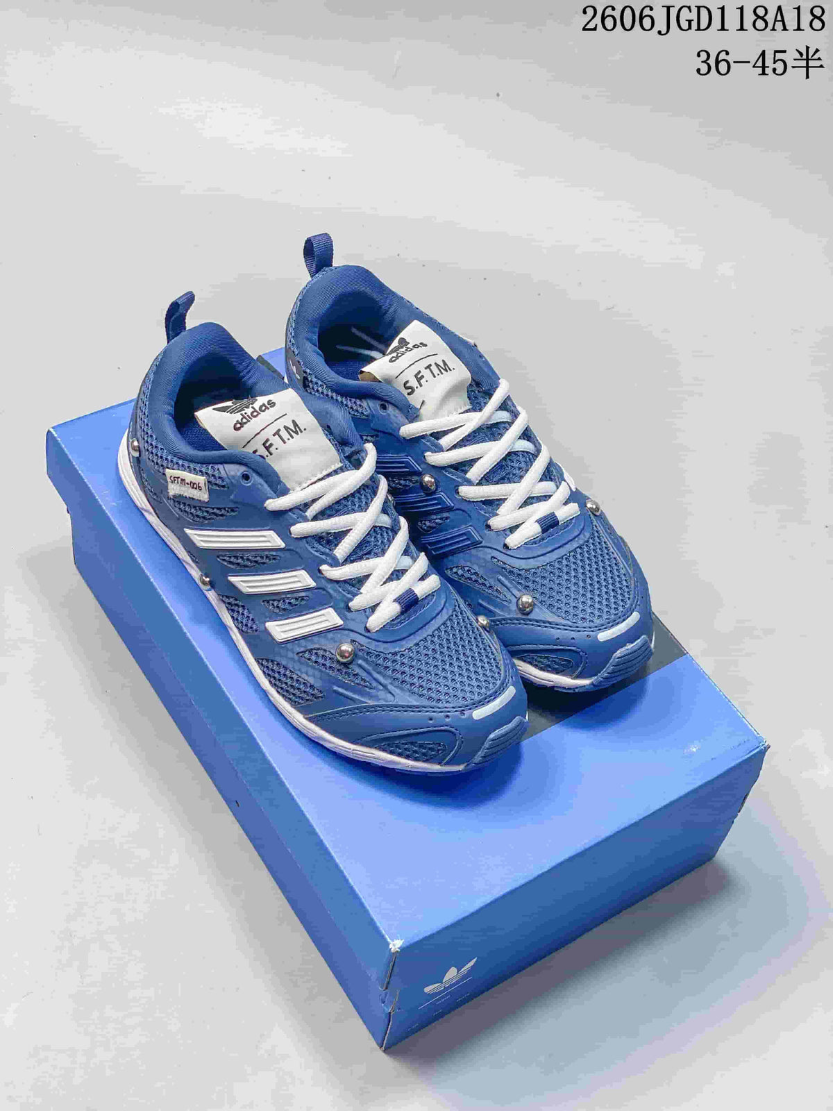 Blue adidas Adizero PR SFTM sneakers with white laces and metallic accents on a blue box
