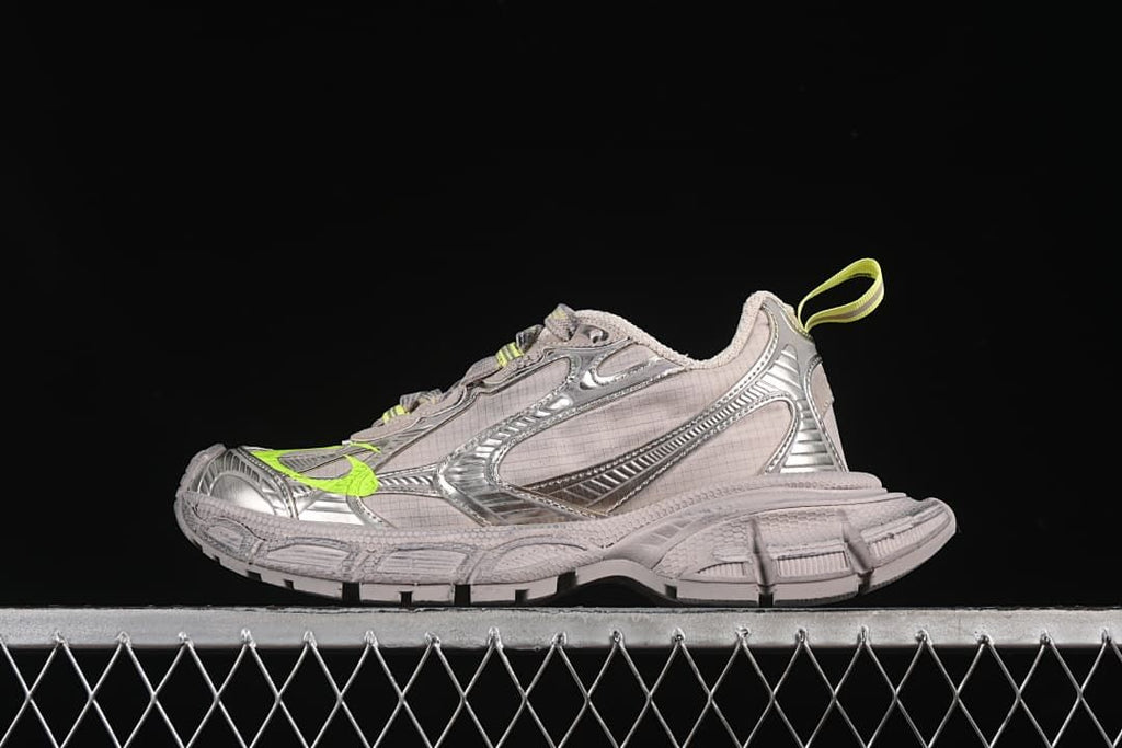 Side view of taupe Balenciaga 3XL sneakers with silver-tone overlays and fluorescent yellow accents