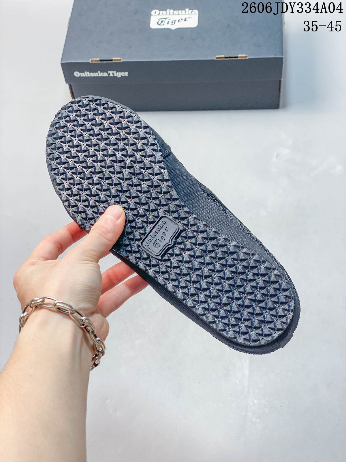 Textured outsole of a dark navy Onitsuka Tiger slip-on shoe.