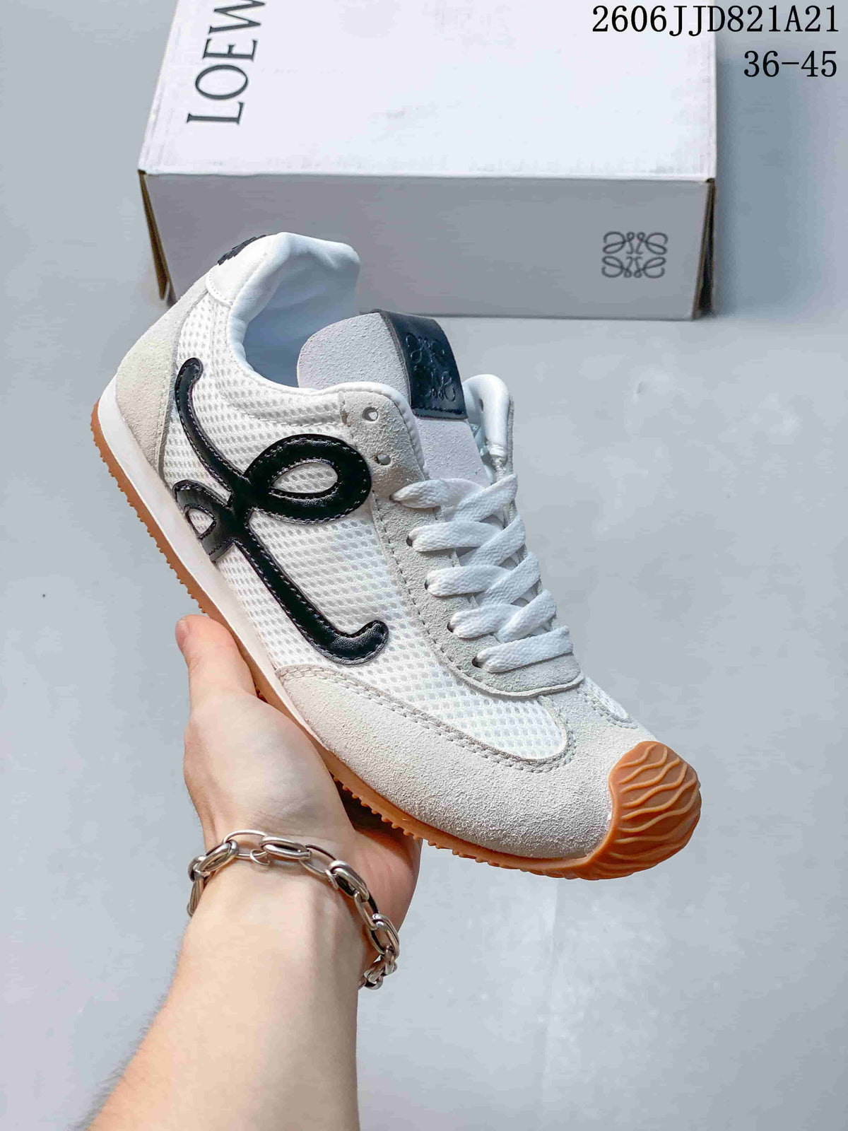 Side view of a white mesh sneaker with dark side detailing