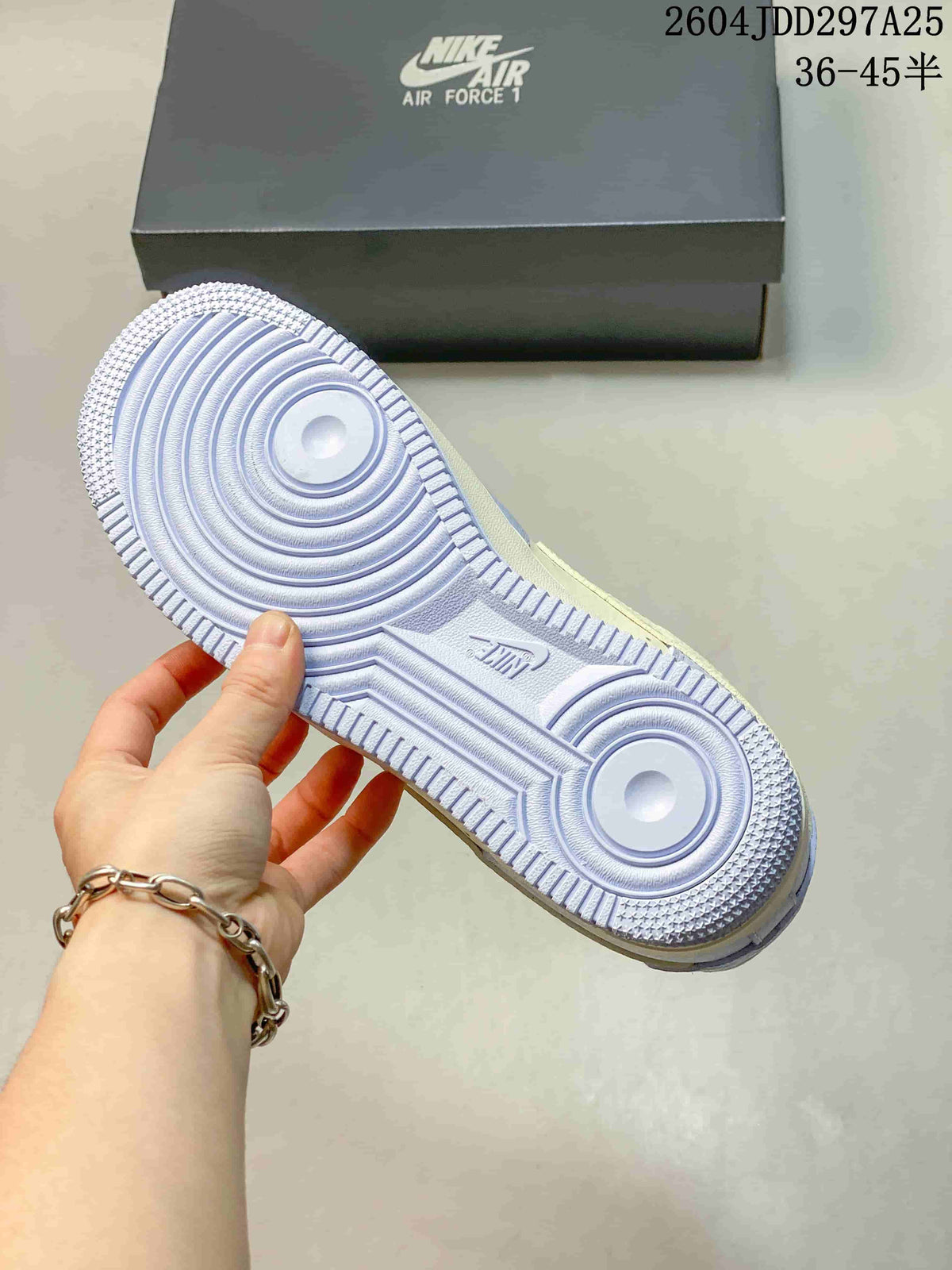 Underside view showing the circular tread pattern on a light blue sneaker outsole