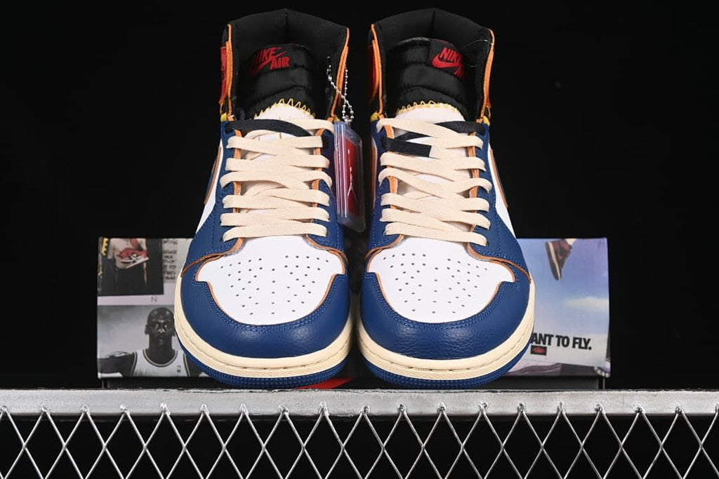 Front view of the pair showing perforated toe panels and cream-colored laces