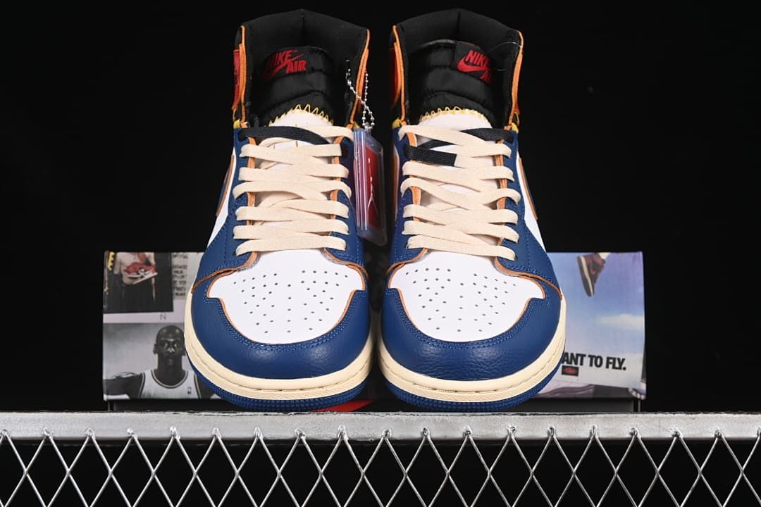 Front view of the pair showing perforated toe panels and cream-colored laces