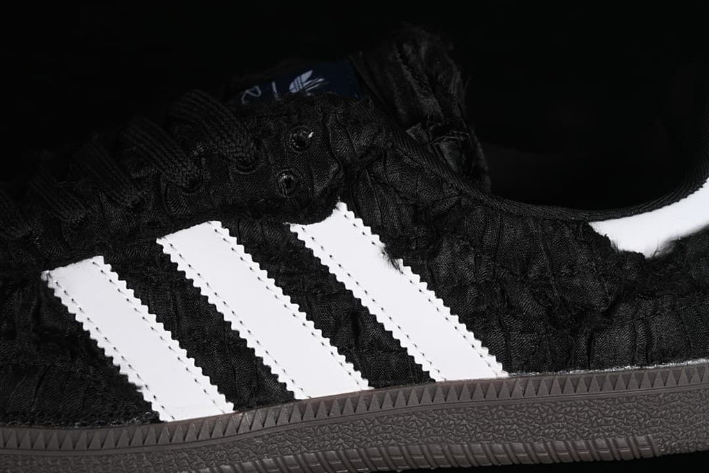 Close-up of the black textured upper and white side stripes