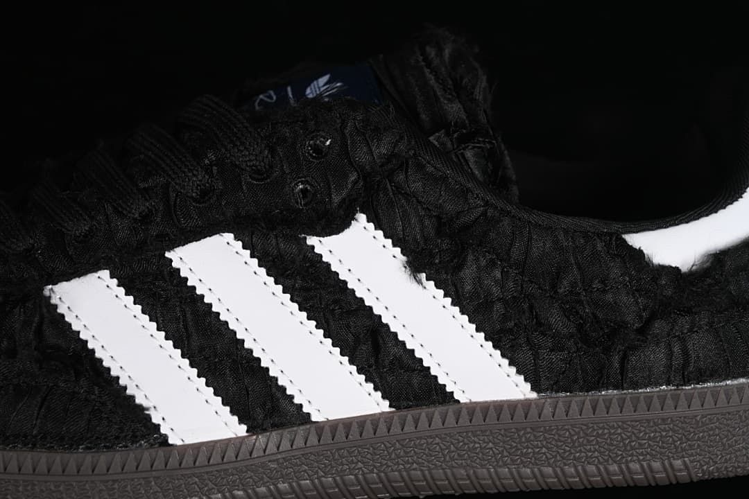 Close-up of the black textured upper and white side stripes