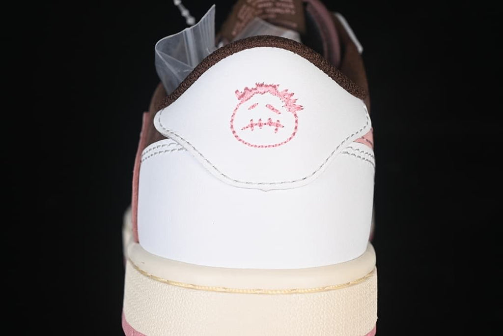 Rear view of the white heel panel with pink graphic detail.