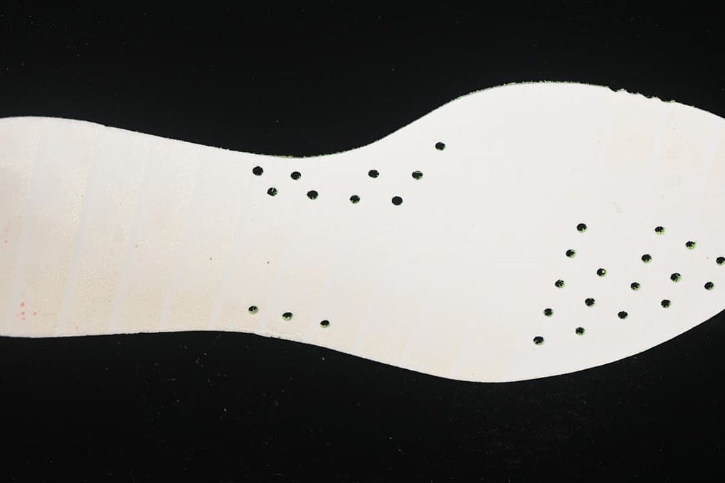 Close-up of the light-colored outsole on the Adidas running shoe.