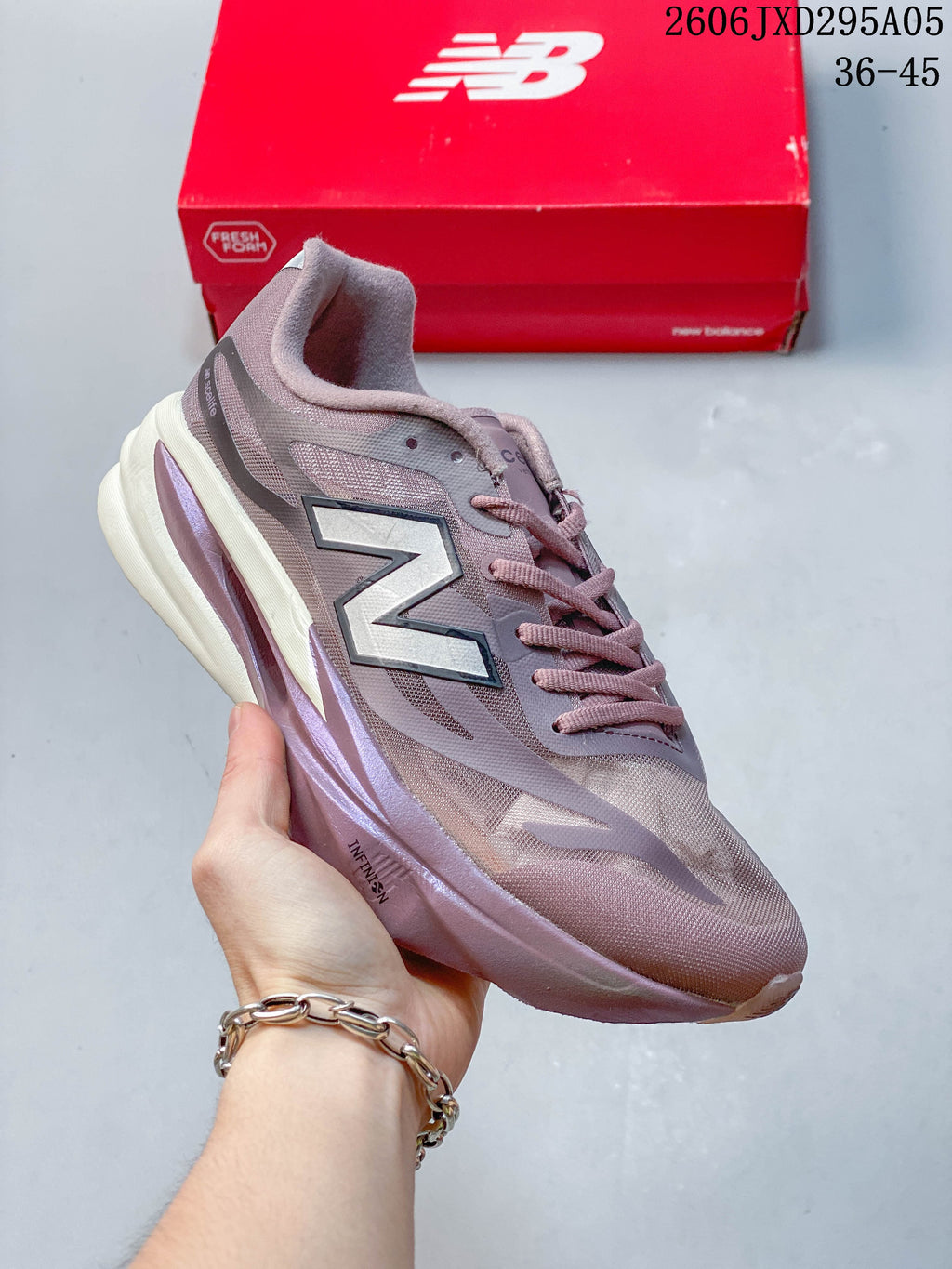 Gray and white New Balance low-top running shoe with a sculpted sole.