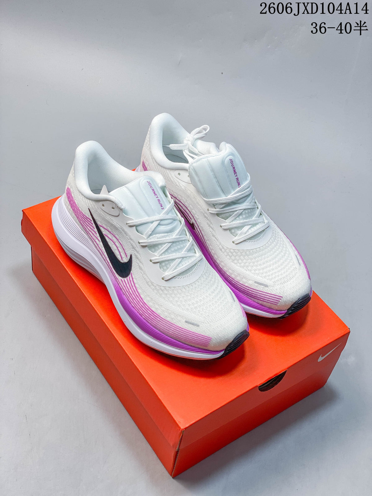 Pair of white Nike Journey Run running shoes with purple accents and dark Swooshes.