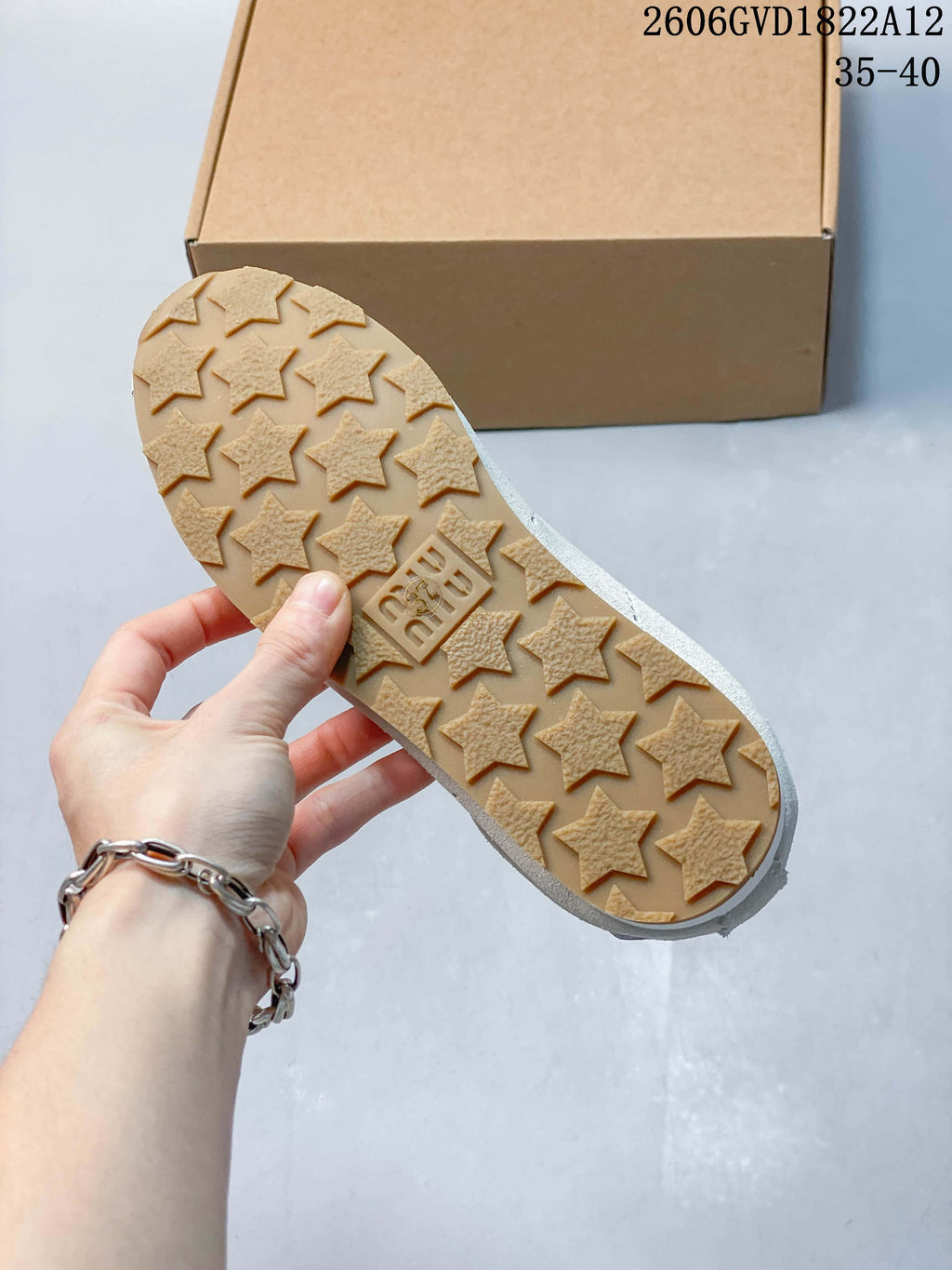 Close-up of the tan-colored outsole with raised star-shaped tread.