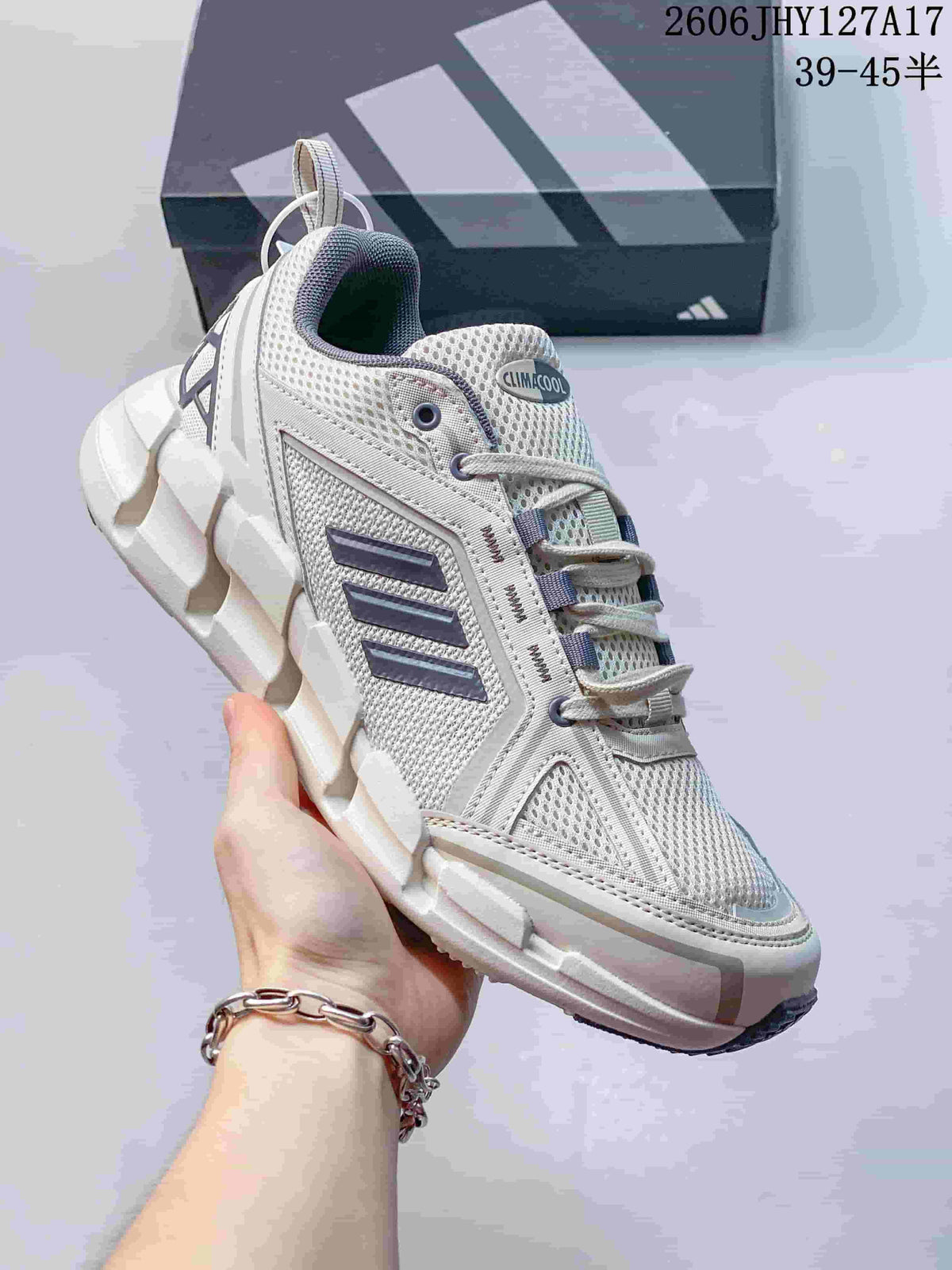 Close view of a white Adidas Climacool Ventage shoe showing the mesh-look upper, dark side stripes, laces and segmented sole.