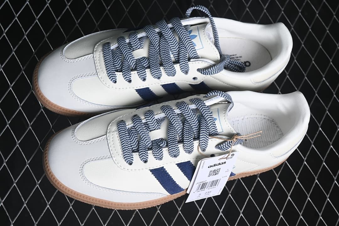 Pair of white and navy sneakers shown from above.