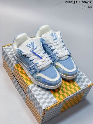 Pair of blue-and-white low-top sneakers displayed on a patterned shoe box.