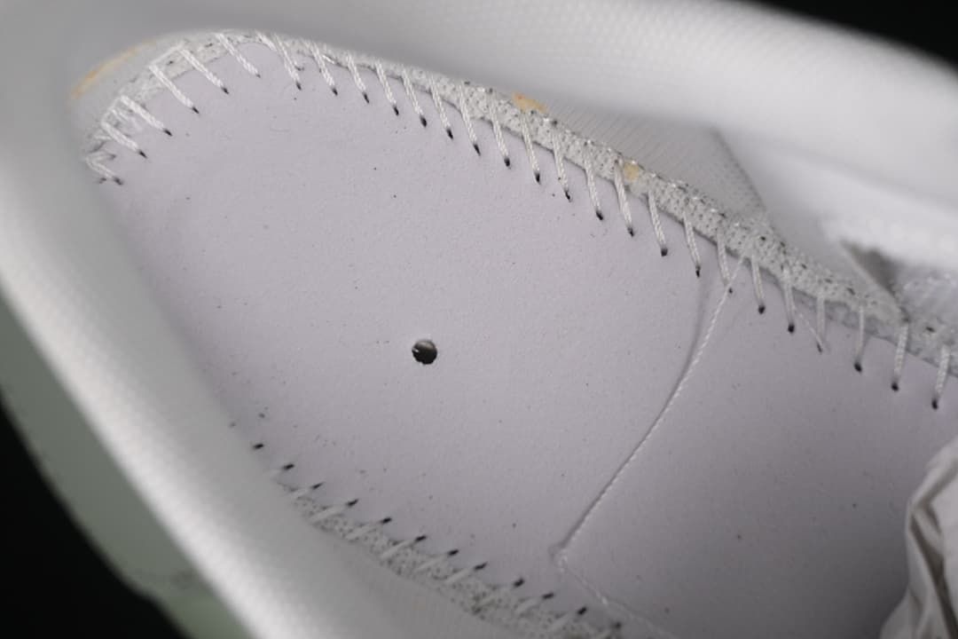 Close detail of stitching and panel construction on the sneaker upper.