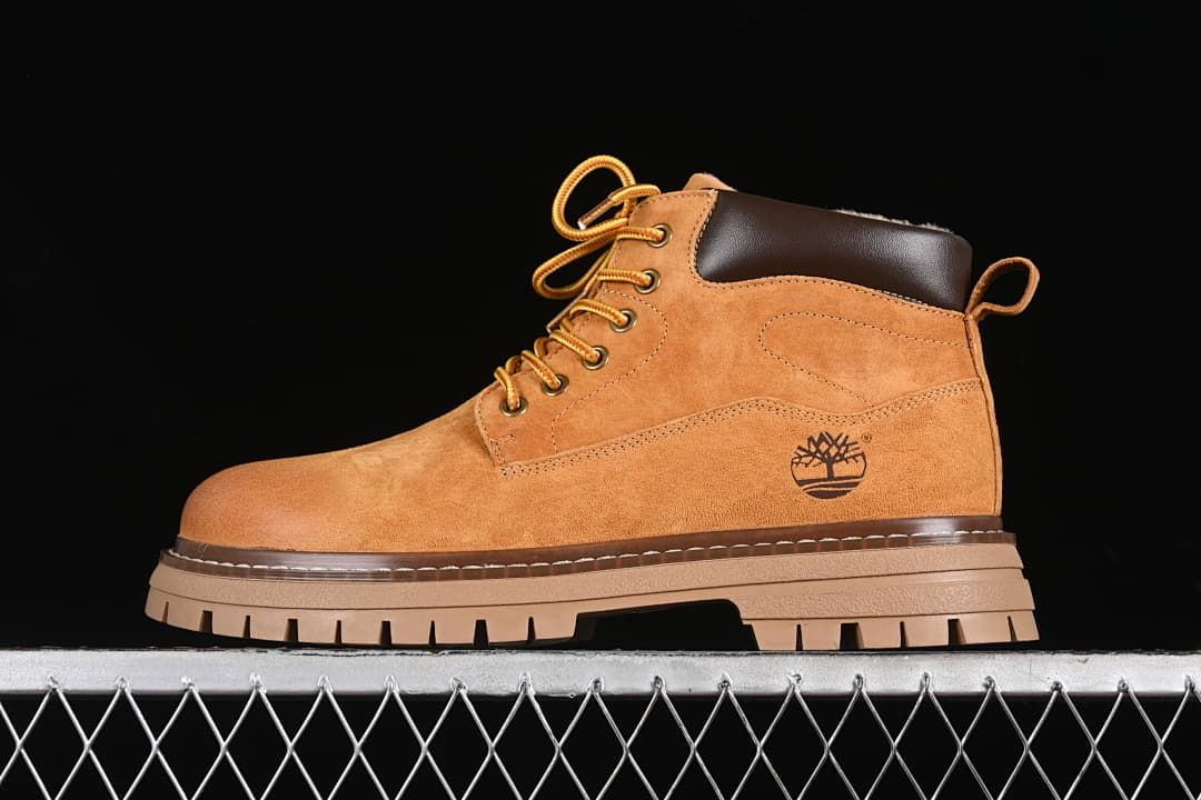 Side view of a yellow-brown Timberland mid-top boot with dark padded collar and lugged sole.