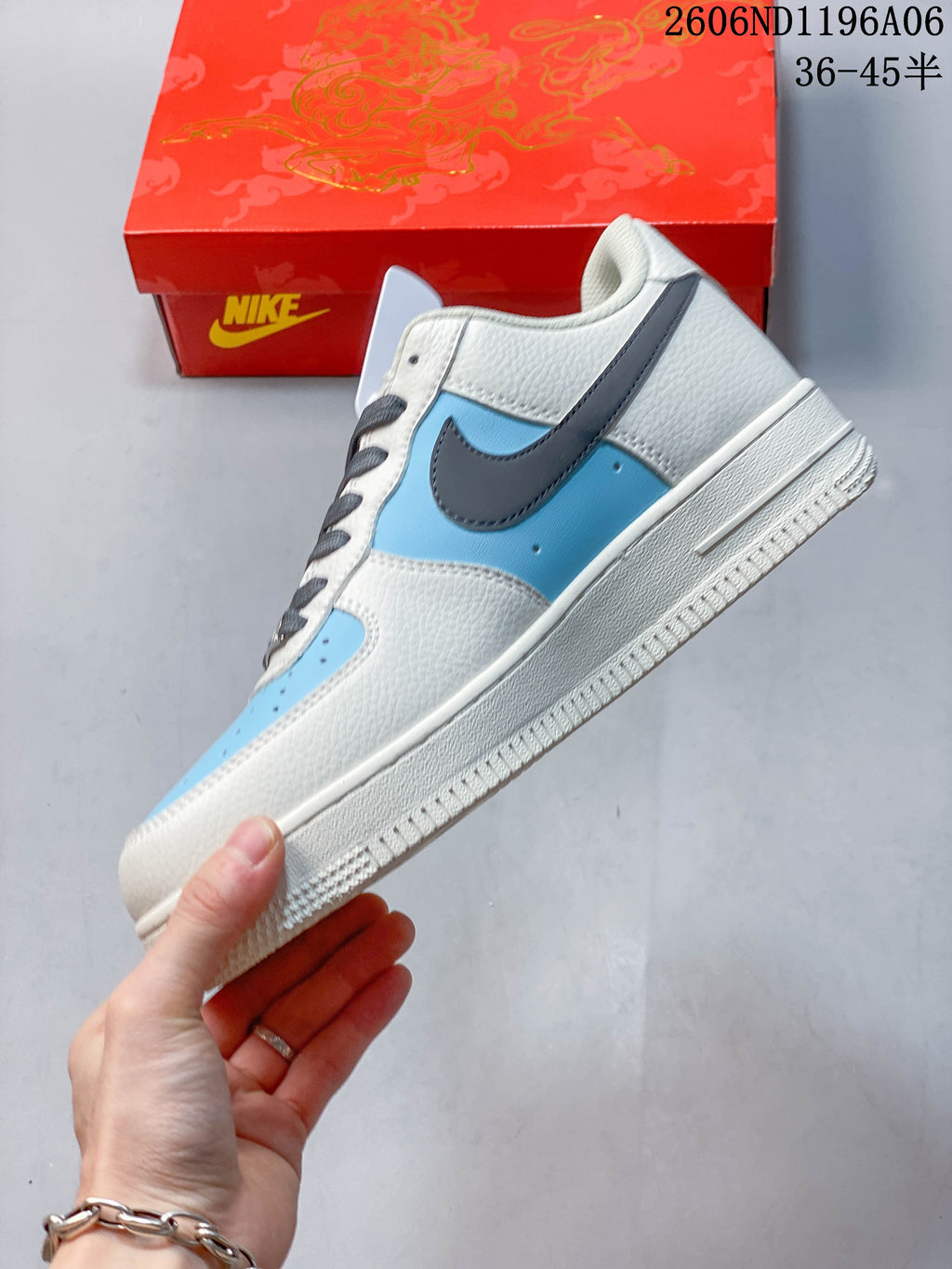 Side profile showing light blue panels, gray Swoosh, and off-white upper.