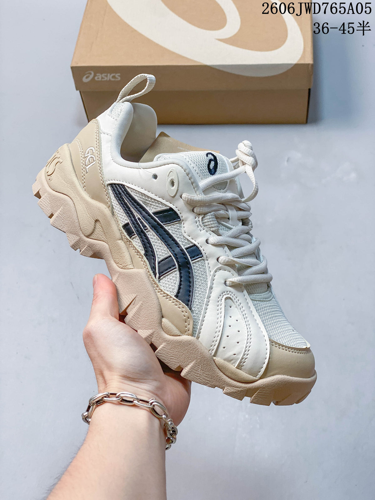 Cream and gray ASICS Gel-TRUCK sneaker with a layered upper and chunky treaded outsole.