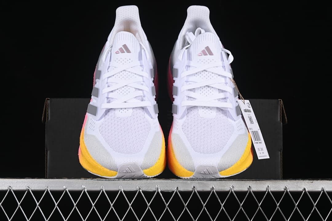 Front view of the pair showing the white uppers and yellow toe accents