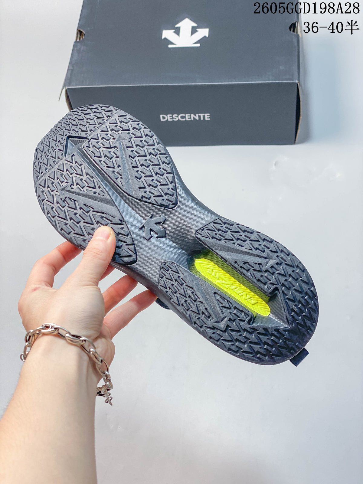 Outsole view showing the patterned tread on a gray DESCENTE shoe