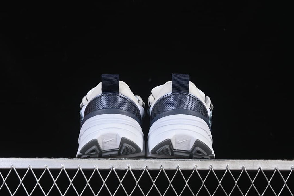 Rear view of both sneakers showing heel panels and outsole design.