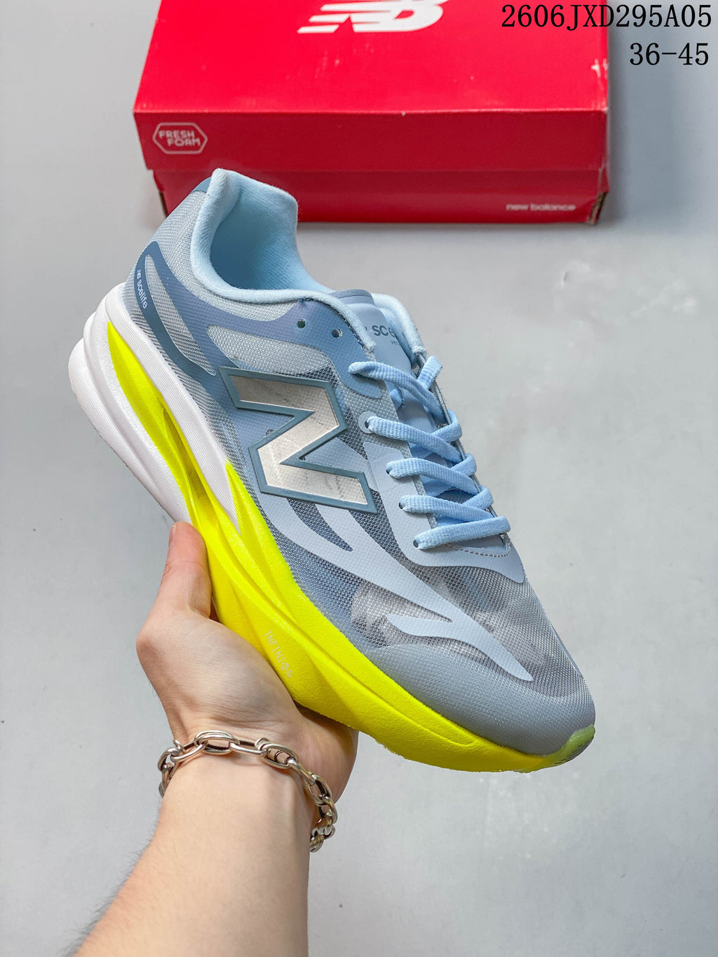 White New Balance low-top running shoe with dark sculpted sole accents.