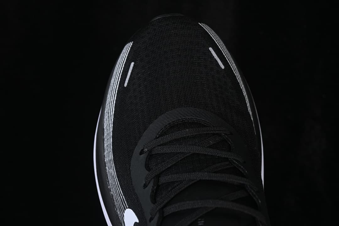 Top view of the black shoe toe and lacing