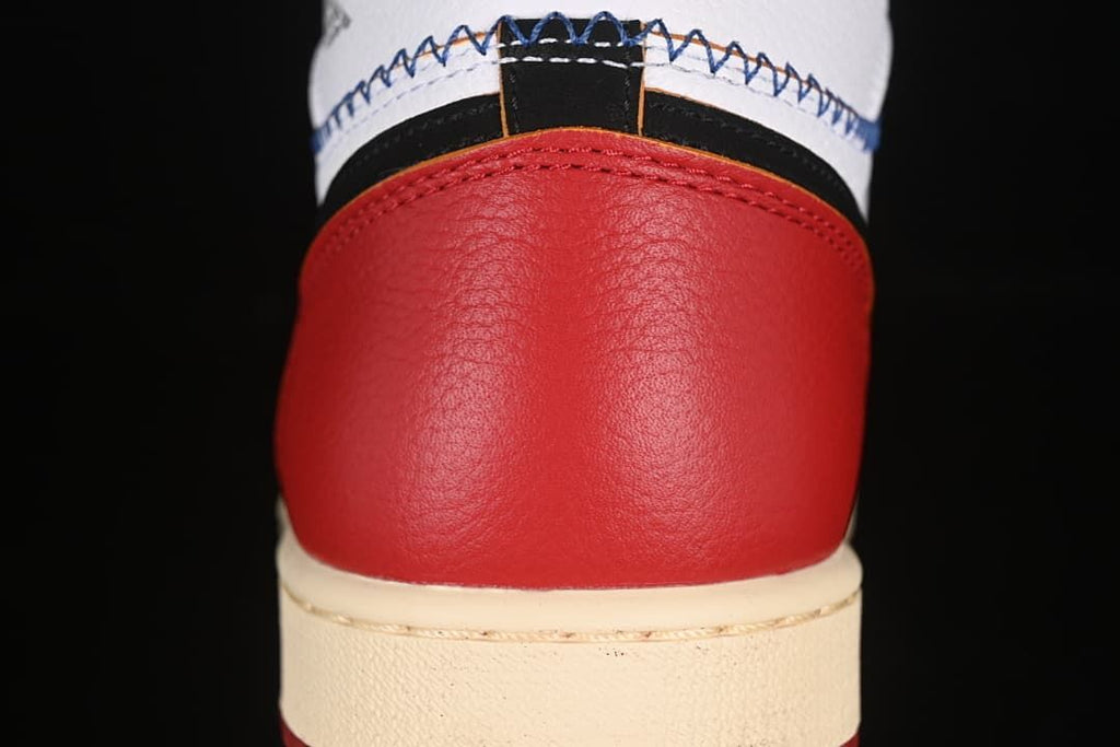 Close-up of the red heel panel and cream midsole