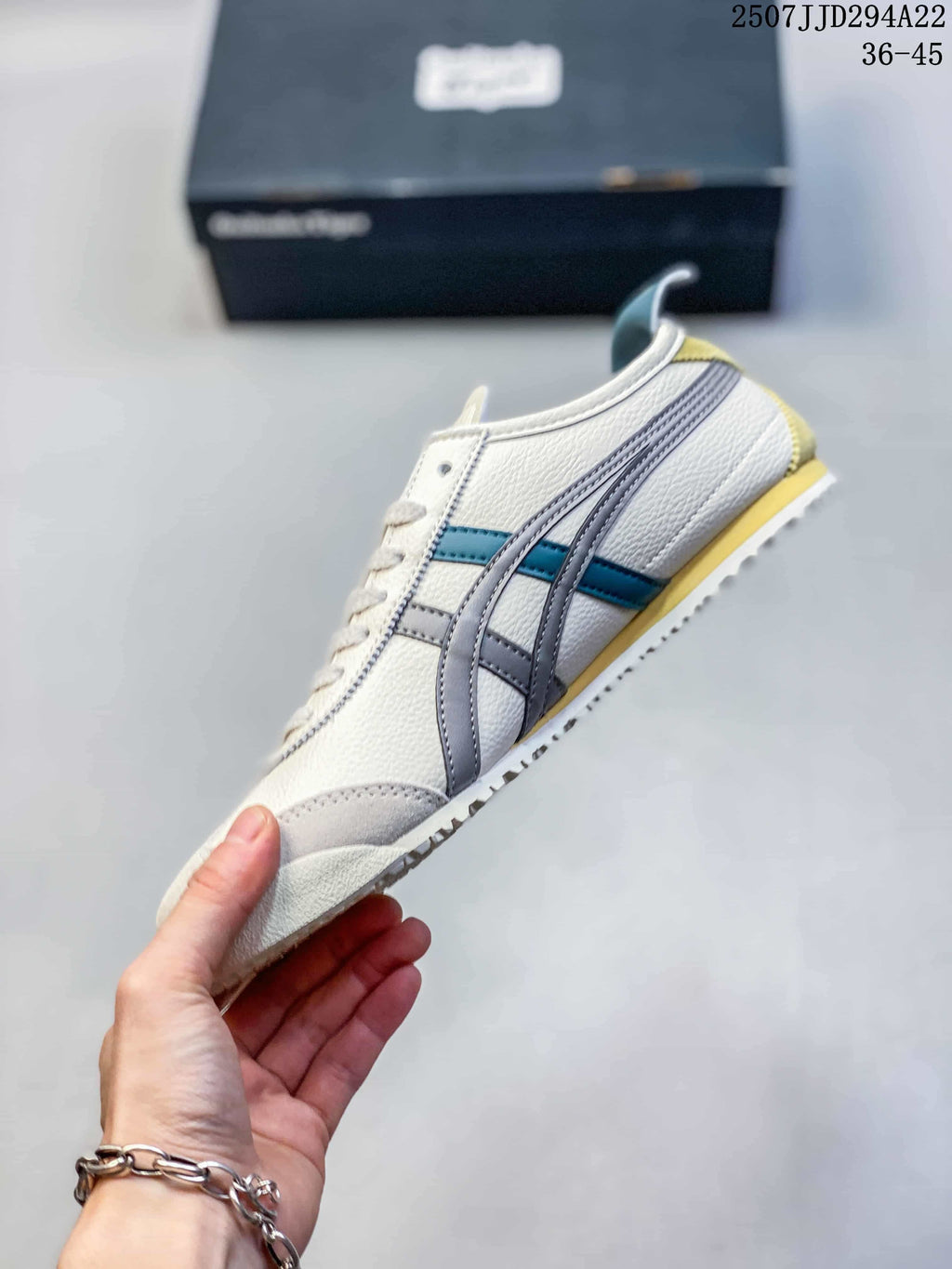 Side profile of a cream sneaker with gray stripes, teal accents, and yellow heel detail