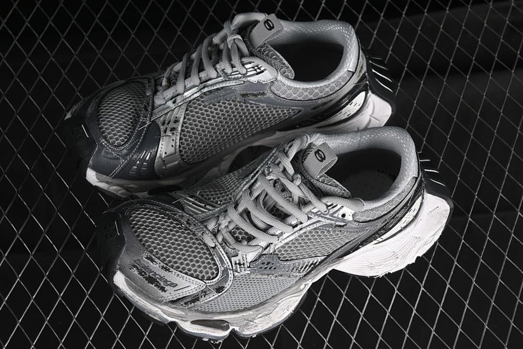 Pair of grey and silver sneakers shown from above at an angle