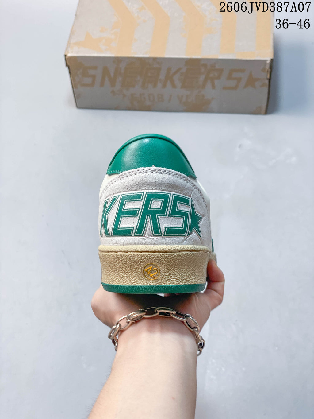 Rear view showing the green heel panel and distressed-look beige sole.