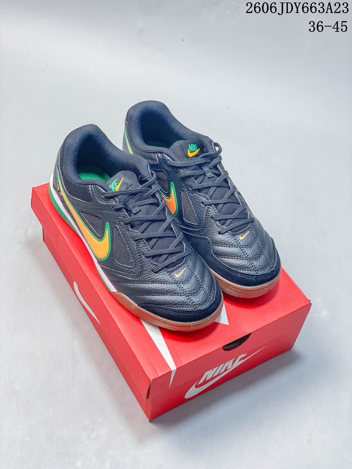 Dark navy Nike Gato low-top sneakers with orange and green accents and gum-colored soles
