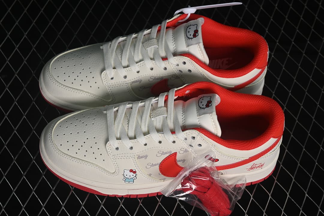 Pair of white and red low-top sneakers with Hello Kitty tongue and side graphics, plus spare red laces.